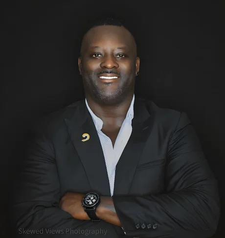Jarvis Green, owner and president of Oceans 97, in a dark suit with his arms crossed