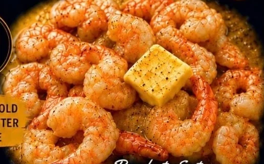 Zulu Butter shrimp chunks in sauce with a pat of butter